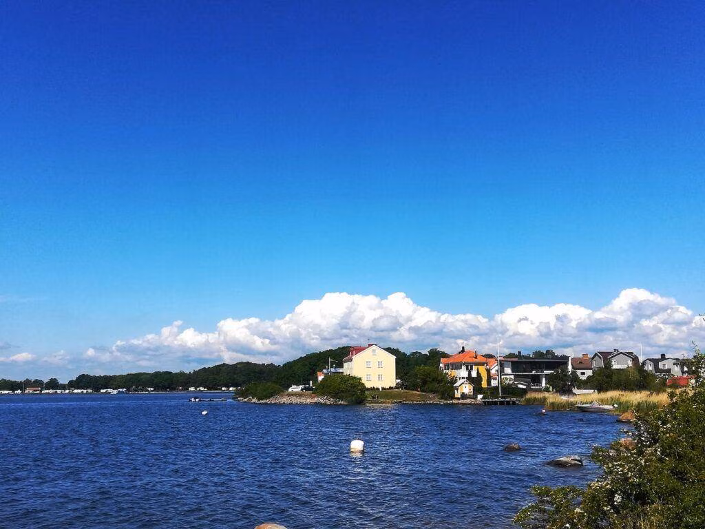 white and red concrete building near body of water during daytime