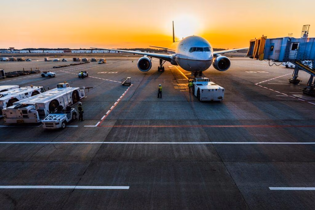 gray airplane on parking
