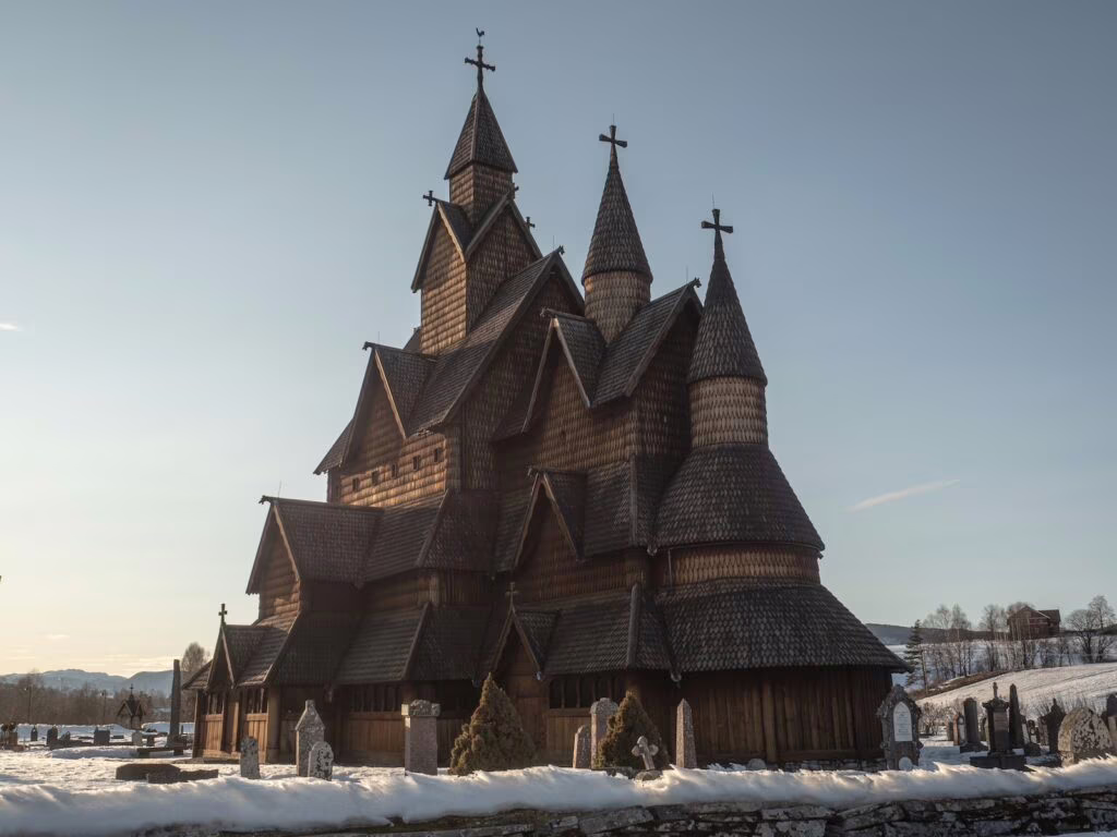 an old wooden church with steeples and crosses
