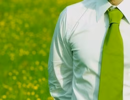business manager outdoor with green necktie