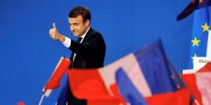 Emmanuel Macron, head of the political movement En Marche !, or Onwards !, and candidate for the 2017 French presidential election, gestures to supporters after the first round of 2017 French presidential election in Paris
