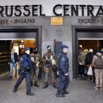 Police control the access to the central train station following bomb attacks in Brussels, Belgium