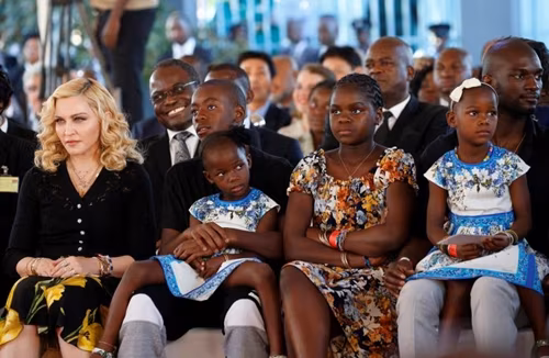 Madonna sits with her adopted children during the opening of Mercy James hospital in Blantyre