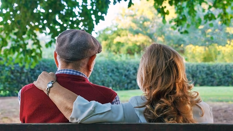 senior couple sitting on a bench