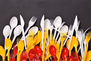 Top view on plastic forks at black background