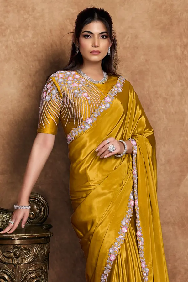 Close-up of pearl handwork on mustard saree