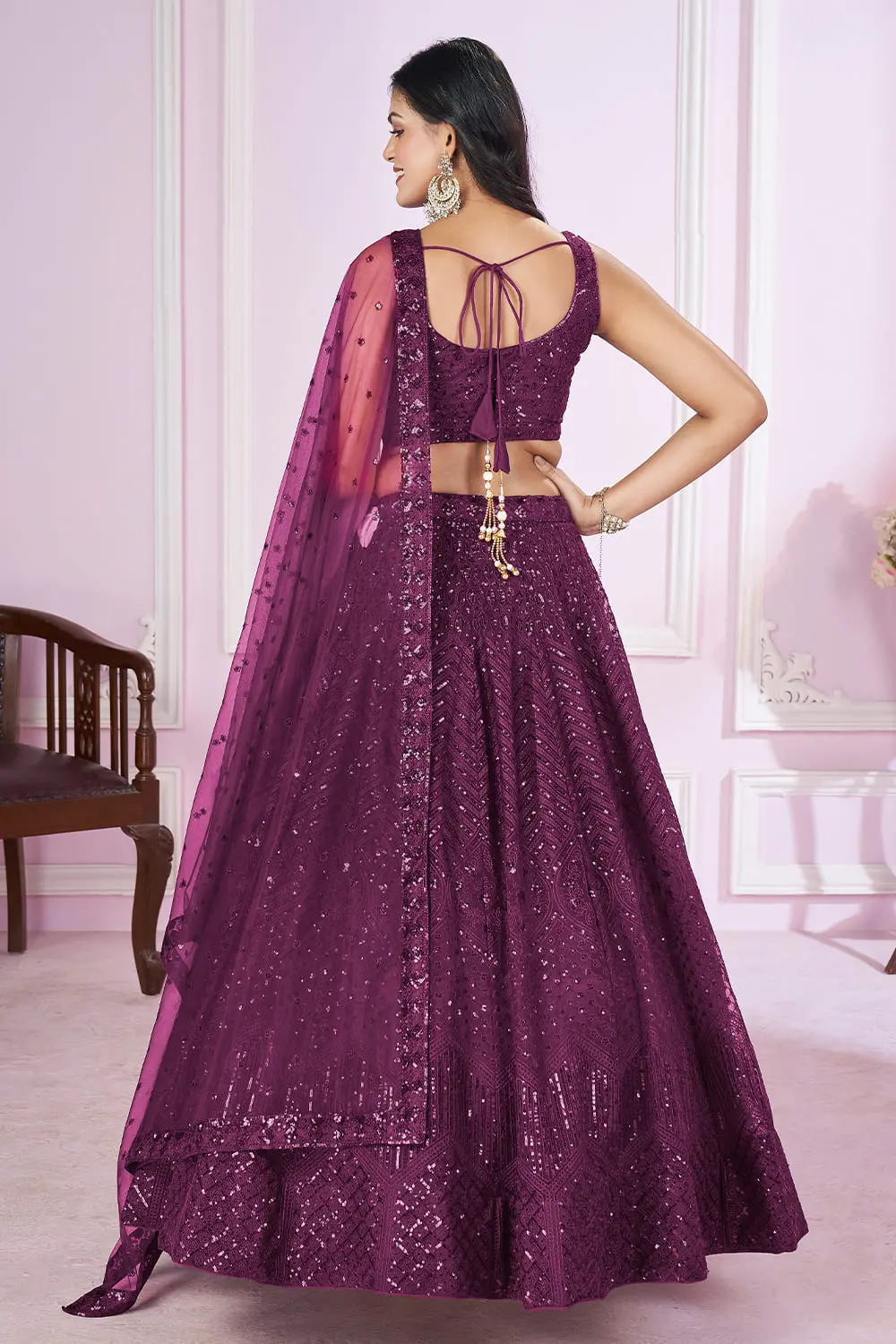 Back view of purple lehenga for wedding with dupatta and zari hemline details