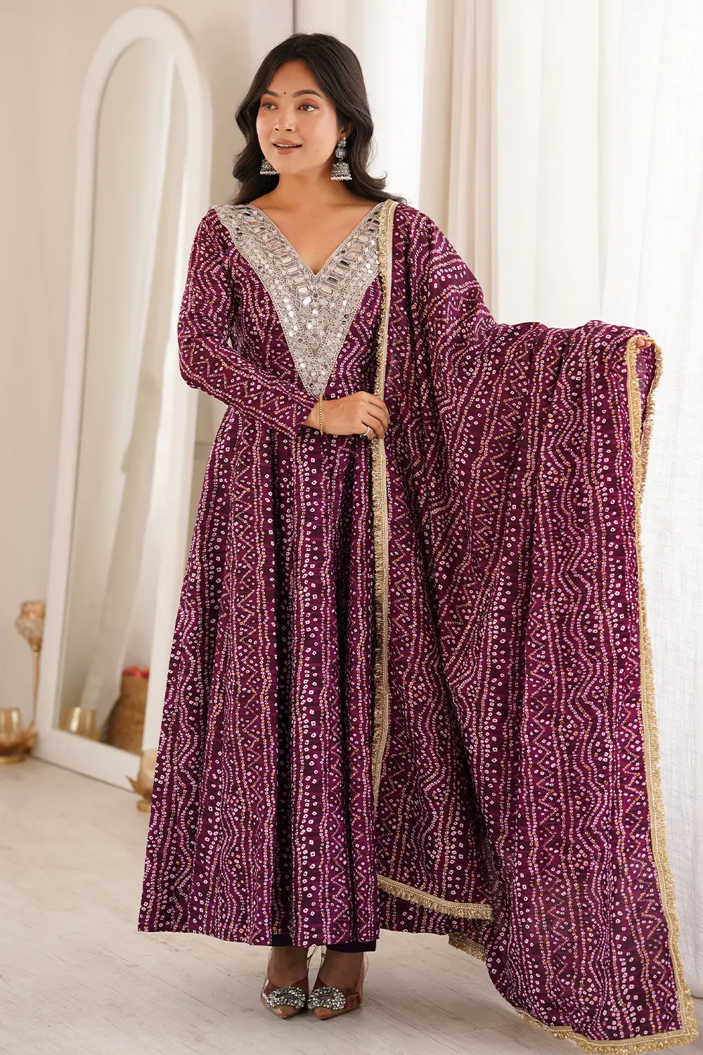 Flared silhouette of purple anarkali gown with mirror work