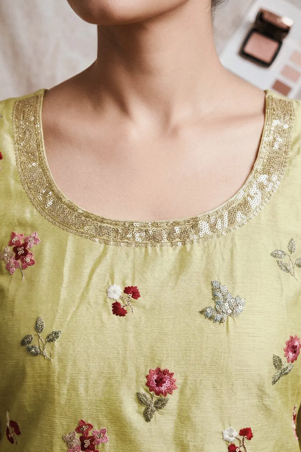 Close up of embroidered light green chinon kurta top