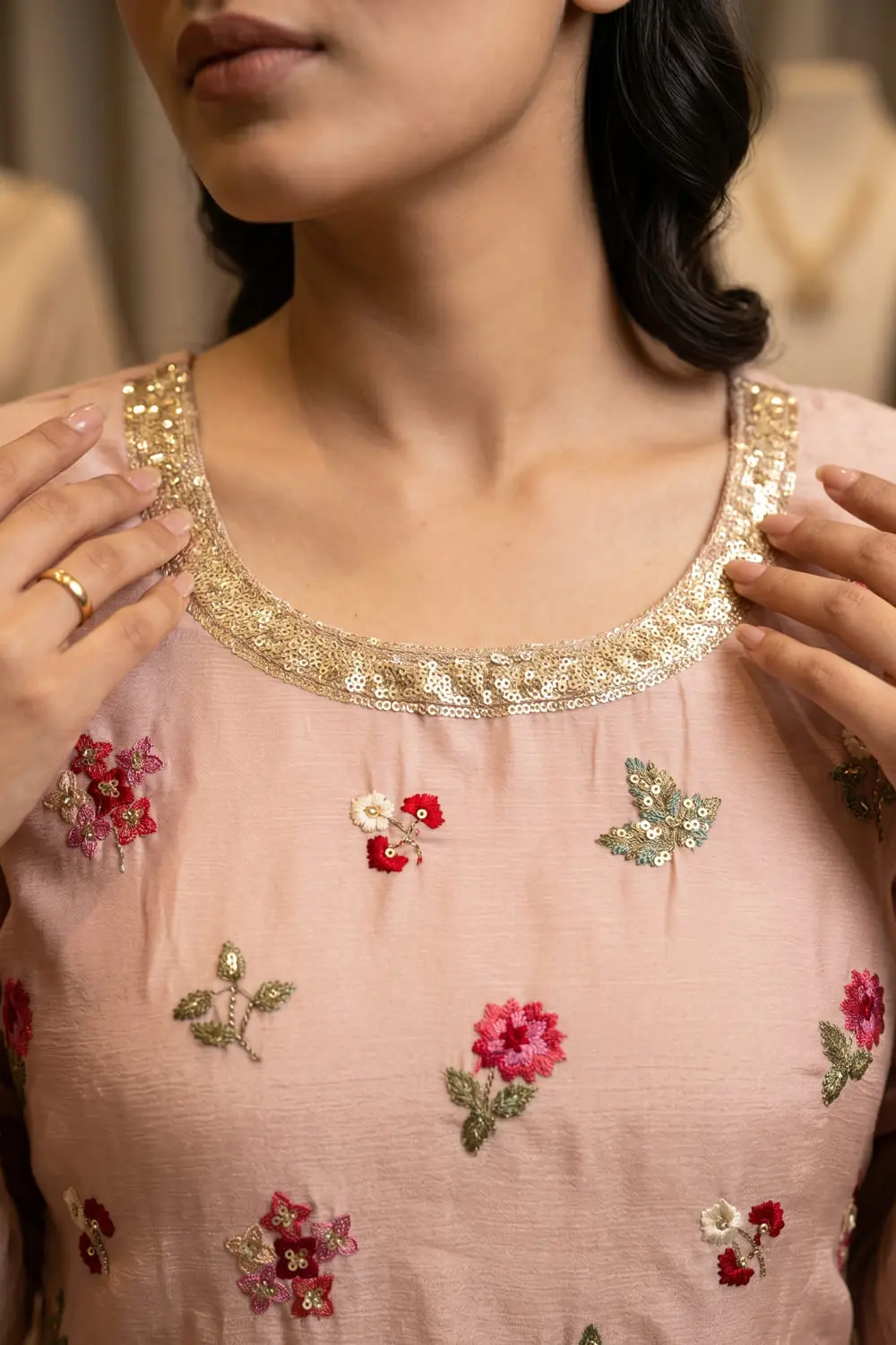 Close up of embroidered light pink chinon kurta top