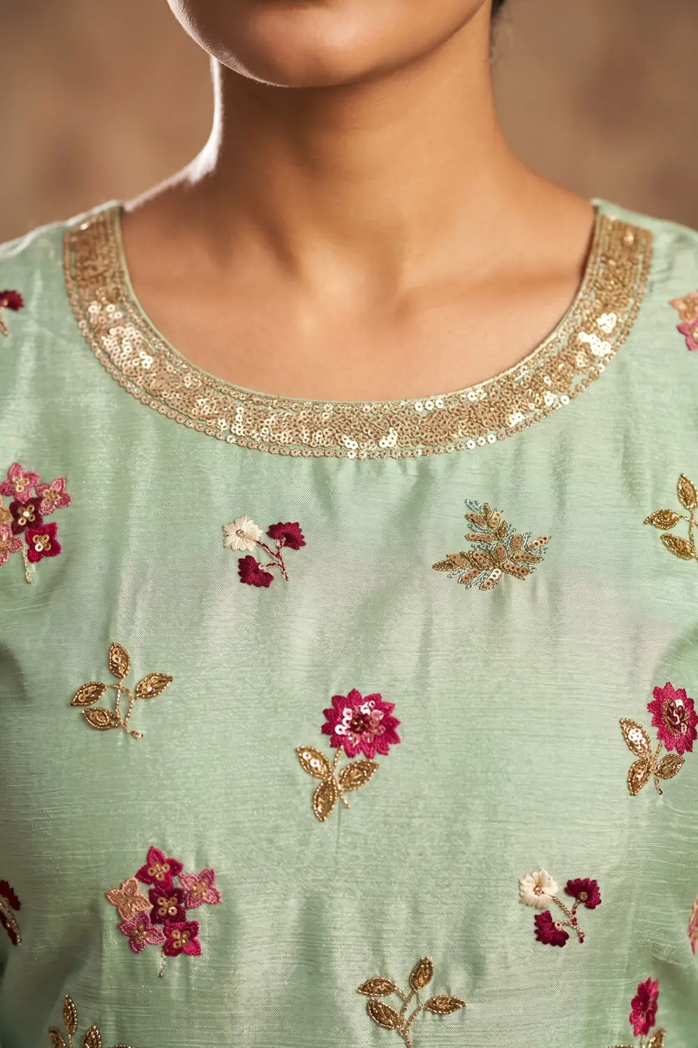 Close up of embroidered sea green chinon kurta top