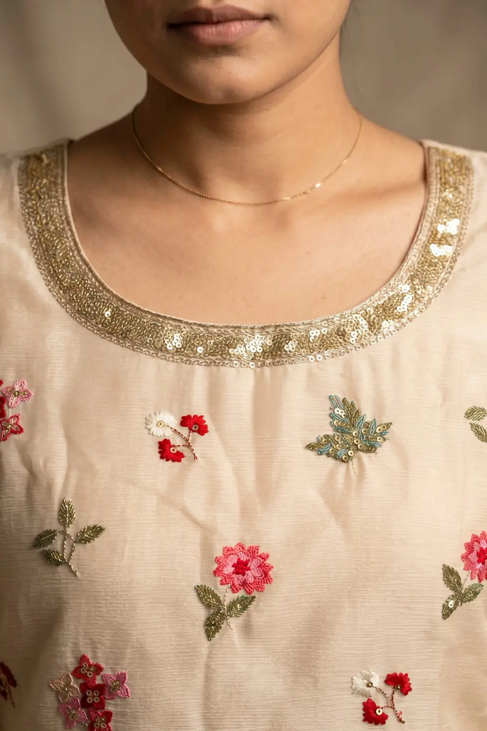 Close up of embroidered peach chinon kurta top