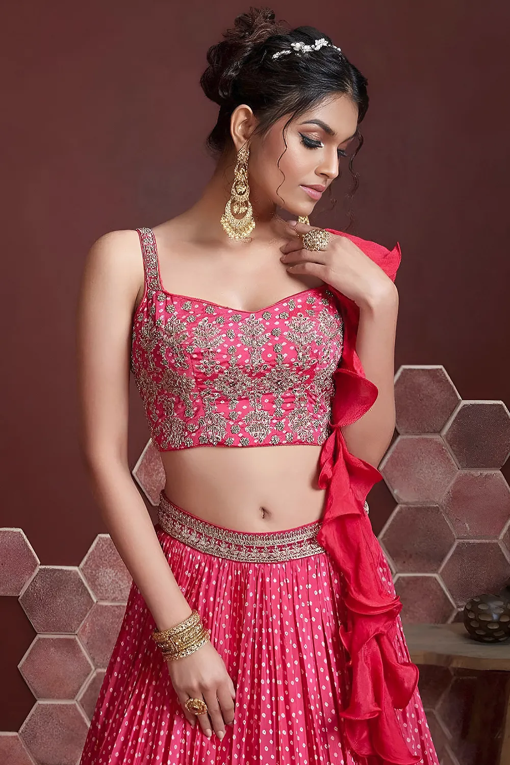 Digital print and embroidery work close up on pink silk lehenga