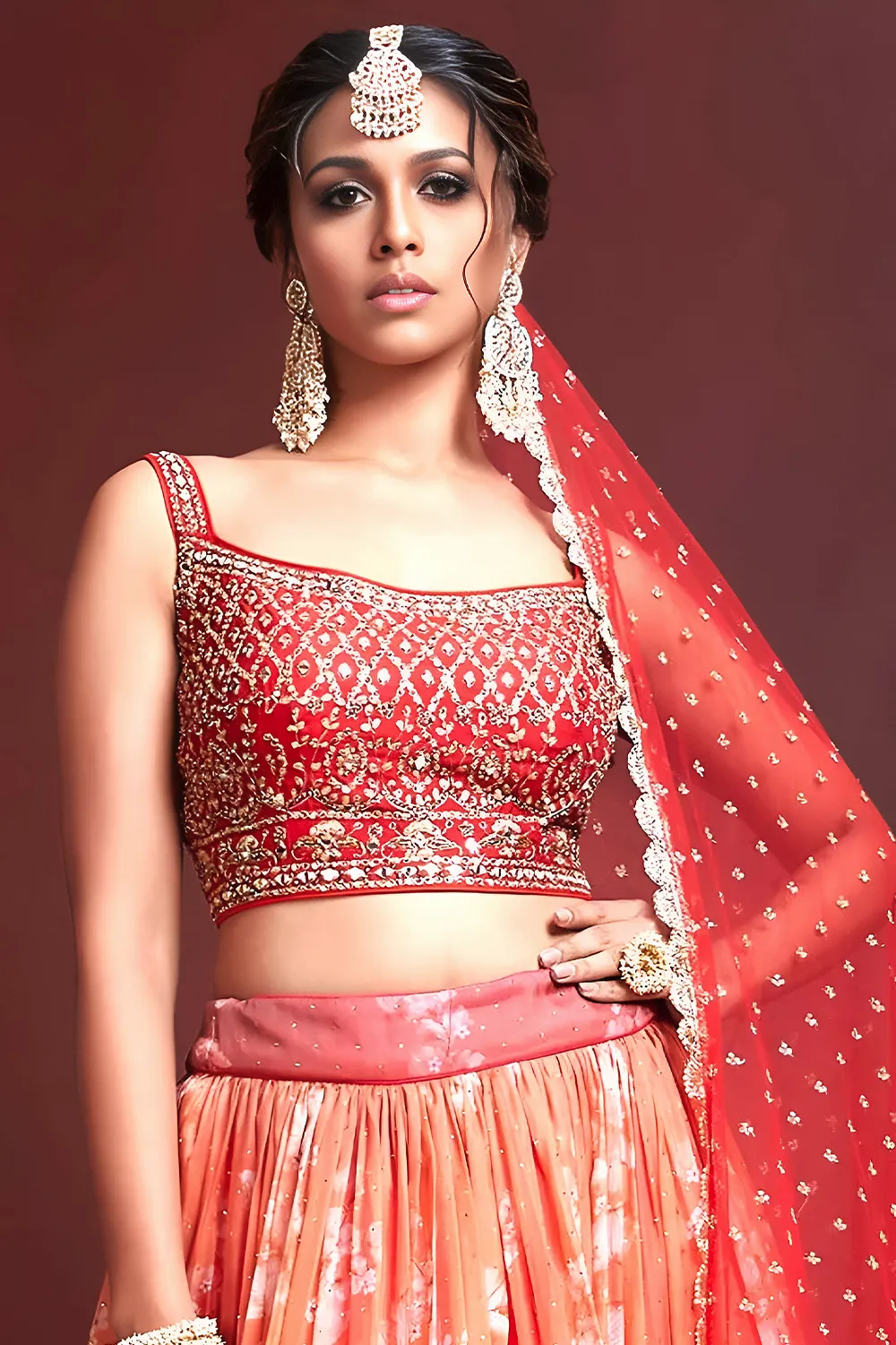 Swarovski crystals and heavy embroidery detail on orange silk lehenga