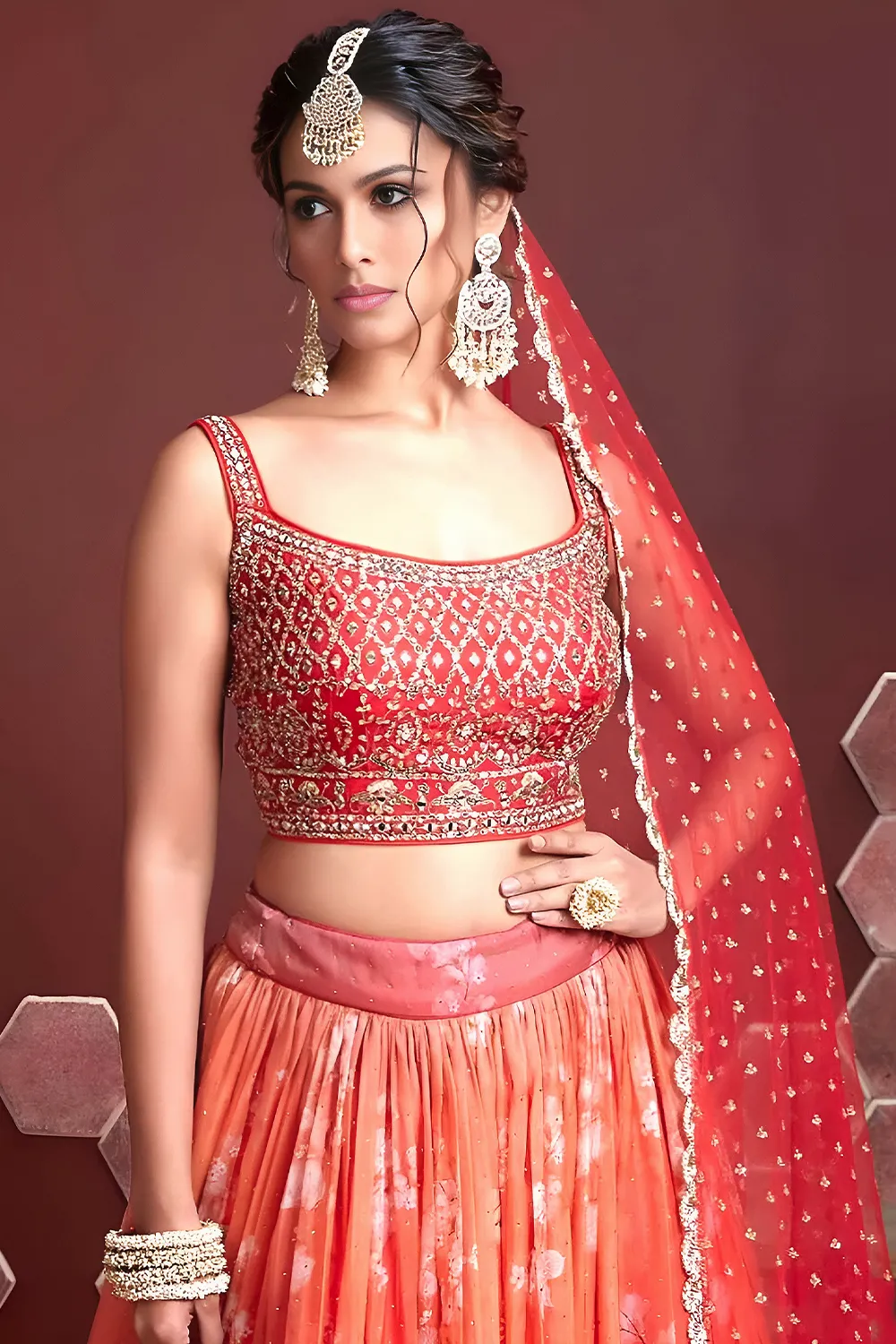 Digital print and embroidery work close up on orange silk lehenga