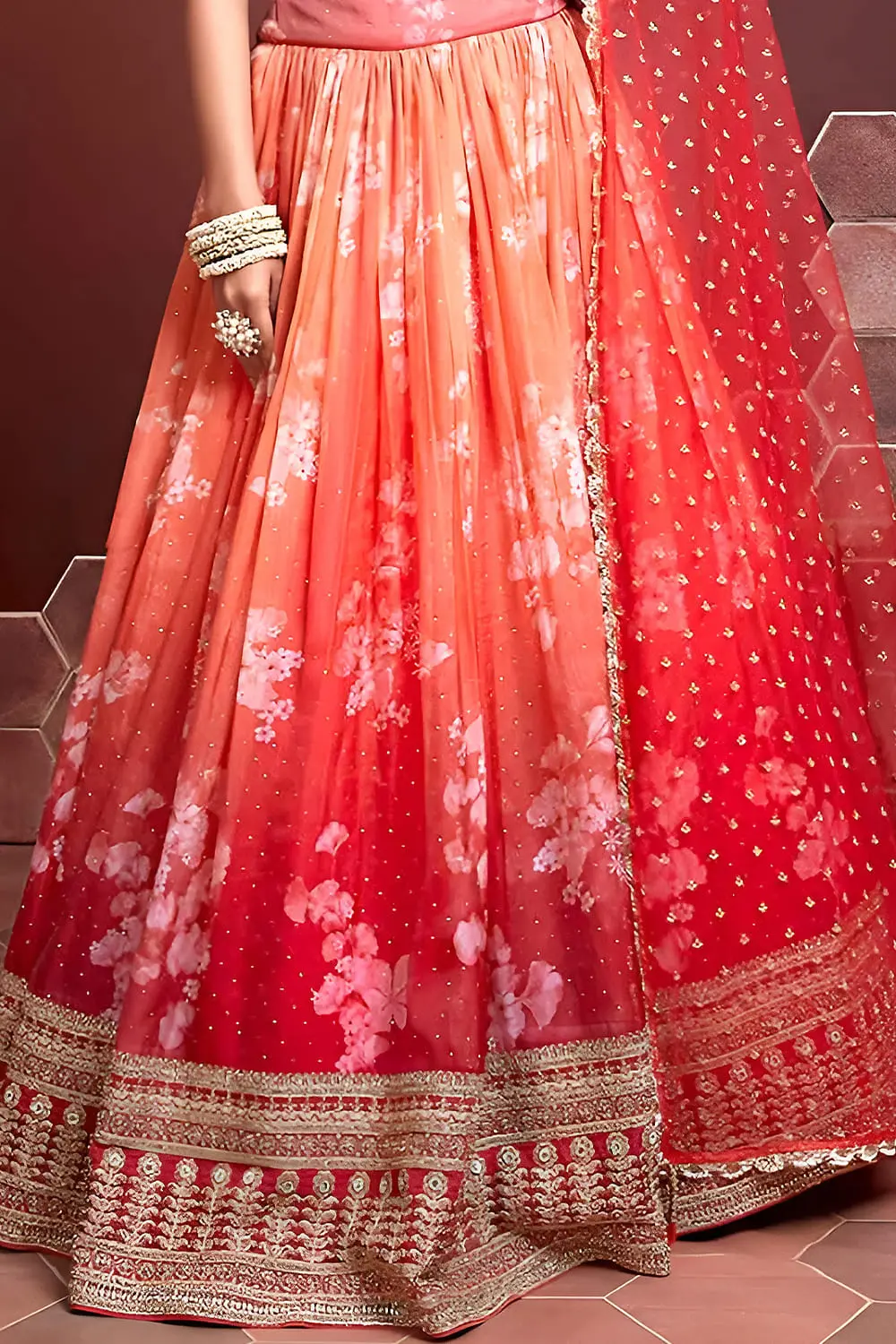 Orange silk lehenga hem with Swarovski and digital print detailing