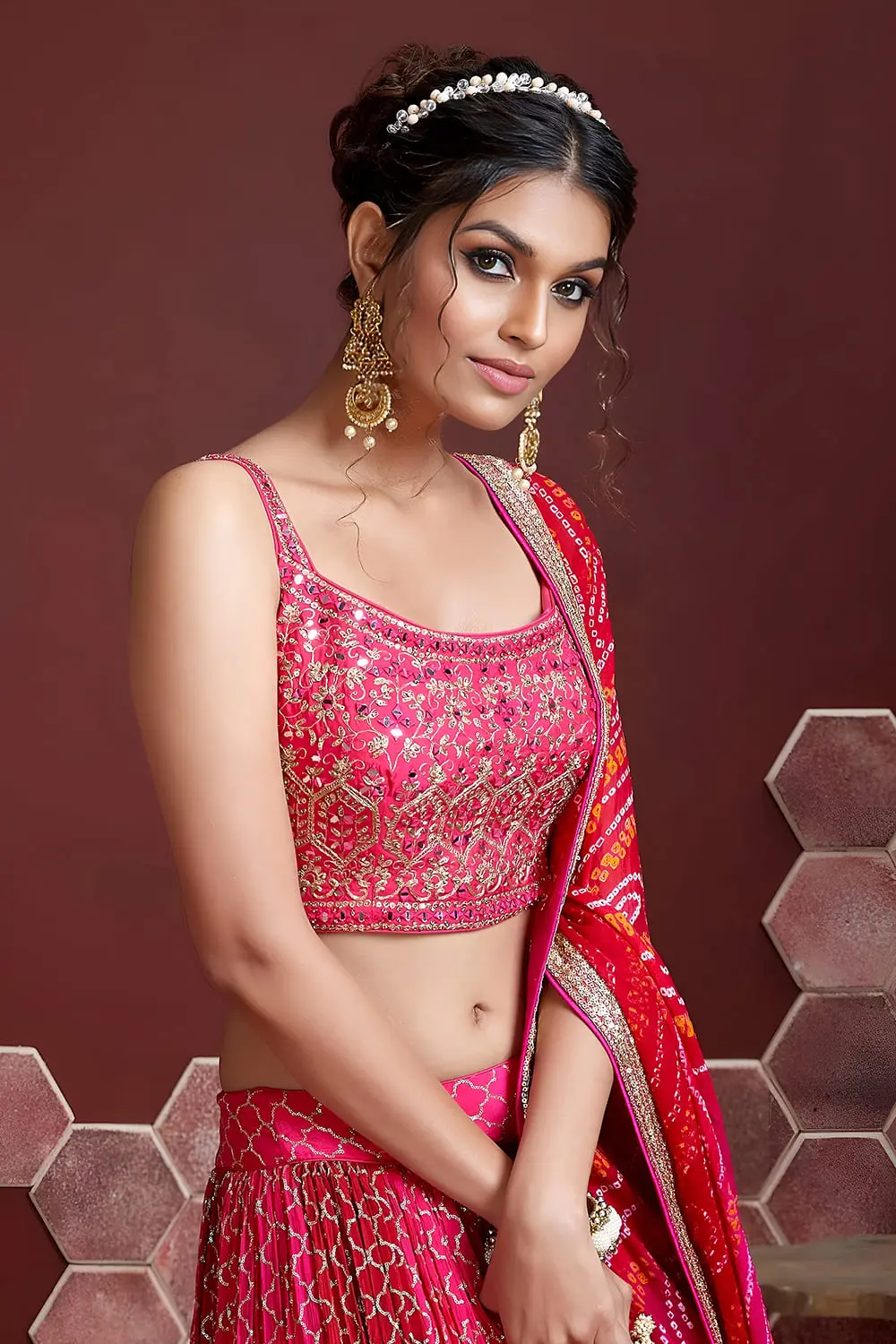 Digital print and embroidery work close up on pink silk lehenga