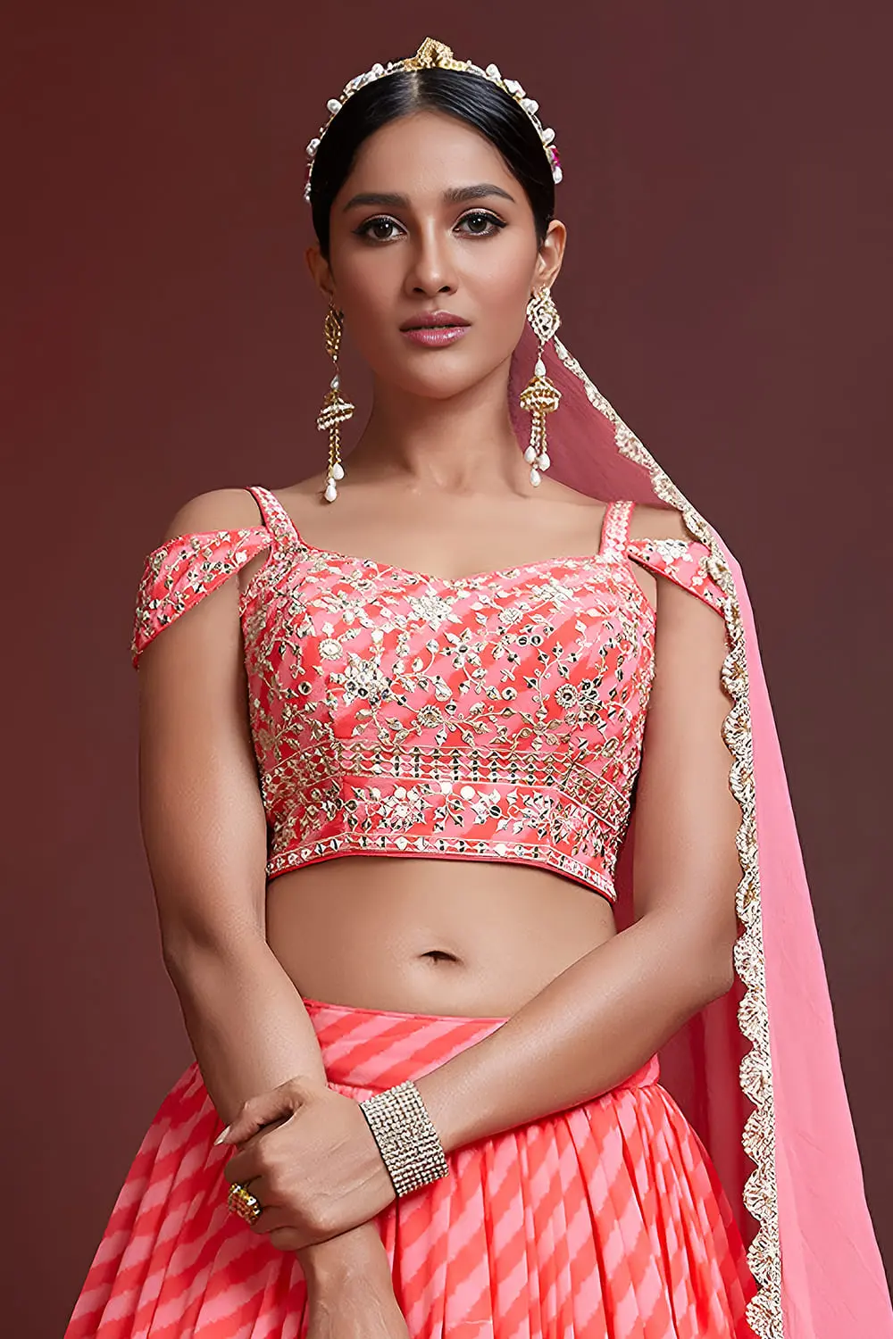 Digital print and embroidery work close up on peach silk lehenga
