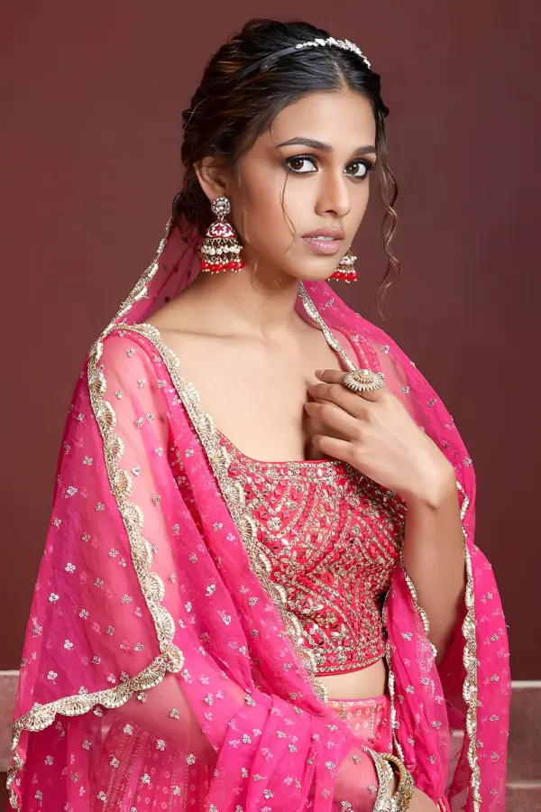 Digital print and embroidery work close up on pink silk lehenga