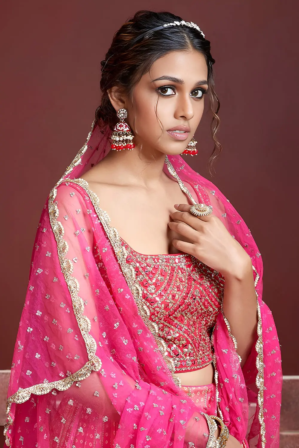 Digital print and embroidery work close up on pink silk lehenga