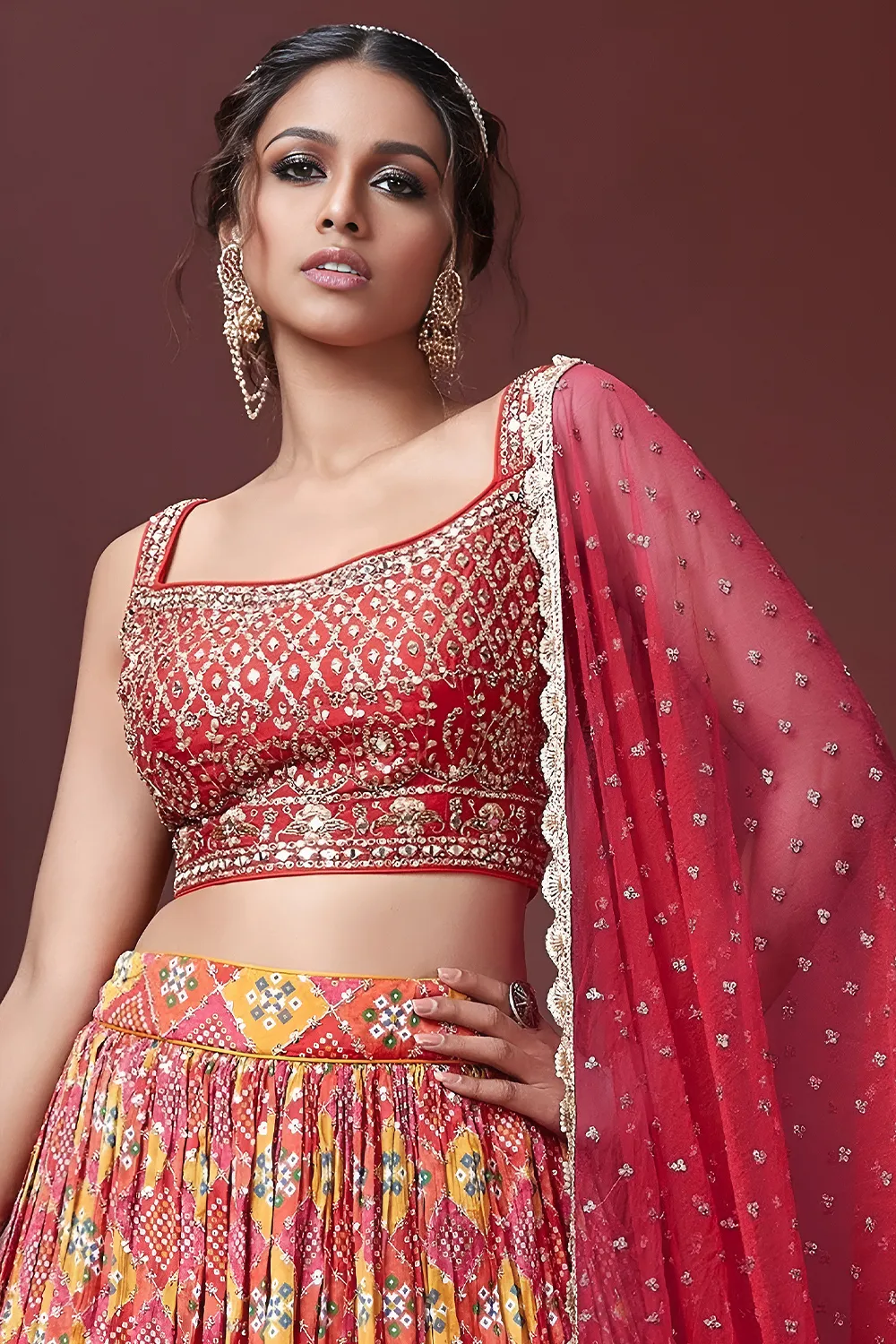 Digital print and embroidery work close up on red silk lehenga