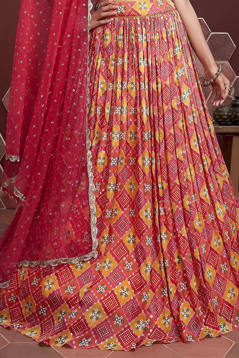 Red silk lehenga hem with Swarovski crystals and digital print