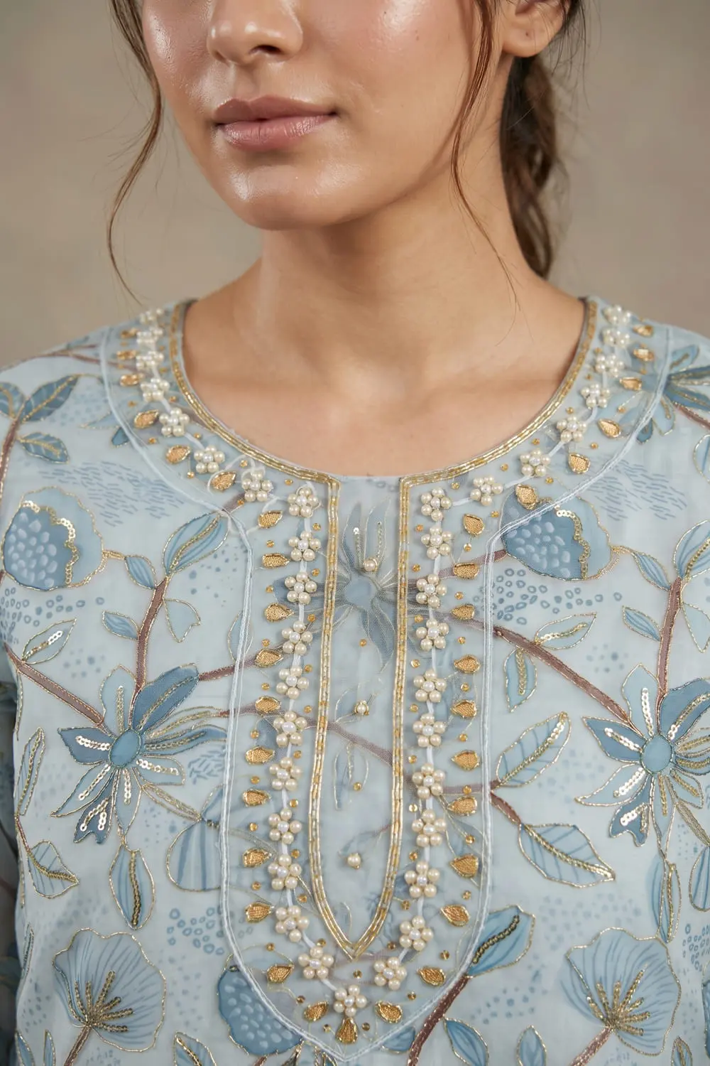 Close up of sky blue organza kurta with handwork detail