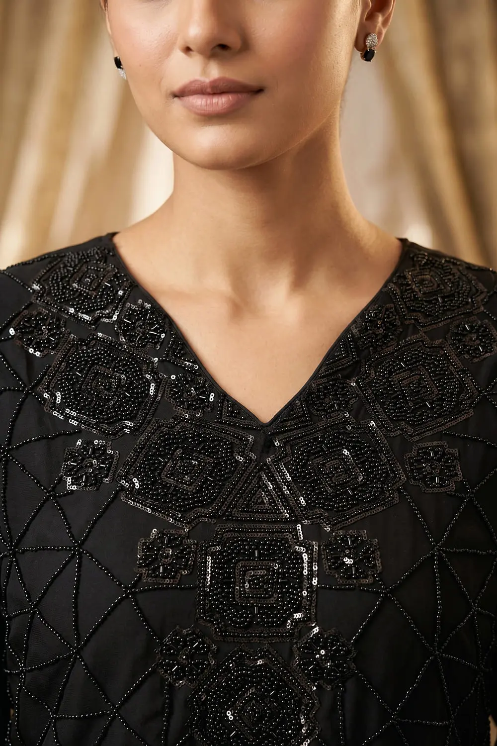 Close up of beaded black chinon kurta top with tassel detail