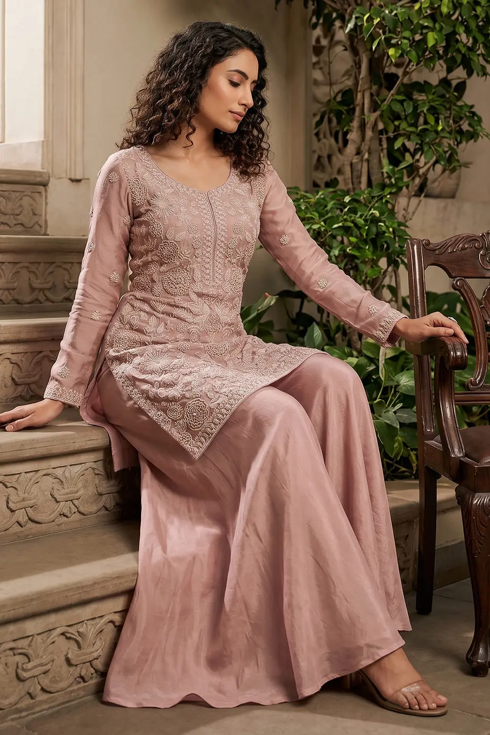 Pink chinon kurta palazzo set with tassel-border dupatta seated view