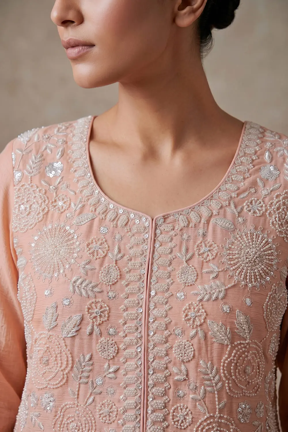 Close up of beaded pink chinon kurta top with tassel detail