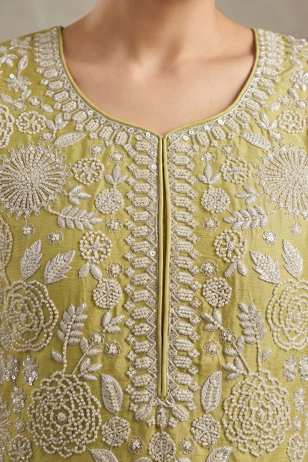 Close up of beaded pistachio green chinon kurta top with tassel detail