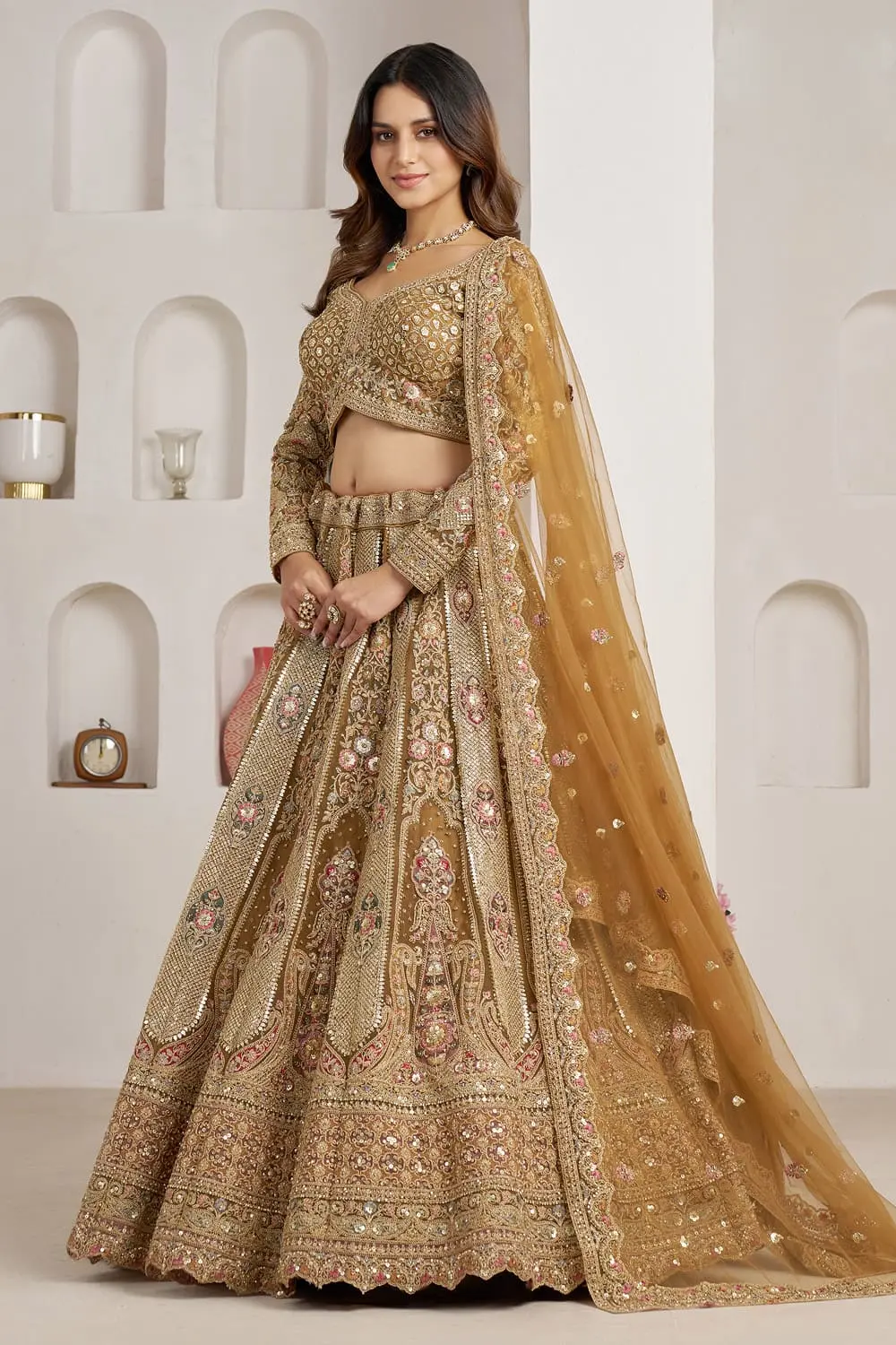 Antique gold bridal lehenga styled with net dupatta and ornate borders