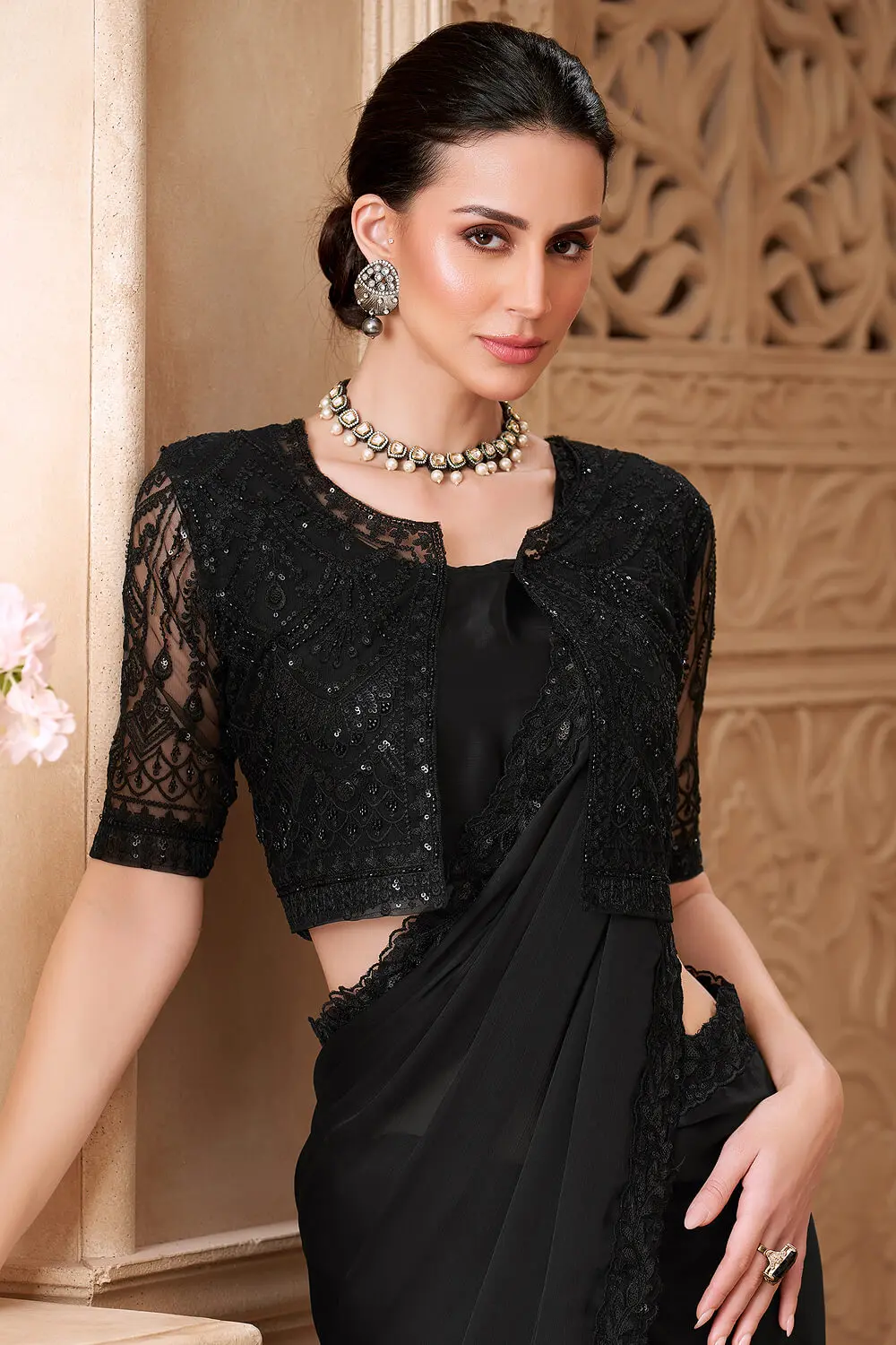 Black satin georgette saree styled with jacket work blouse