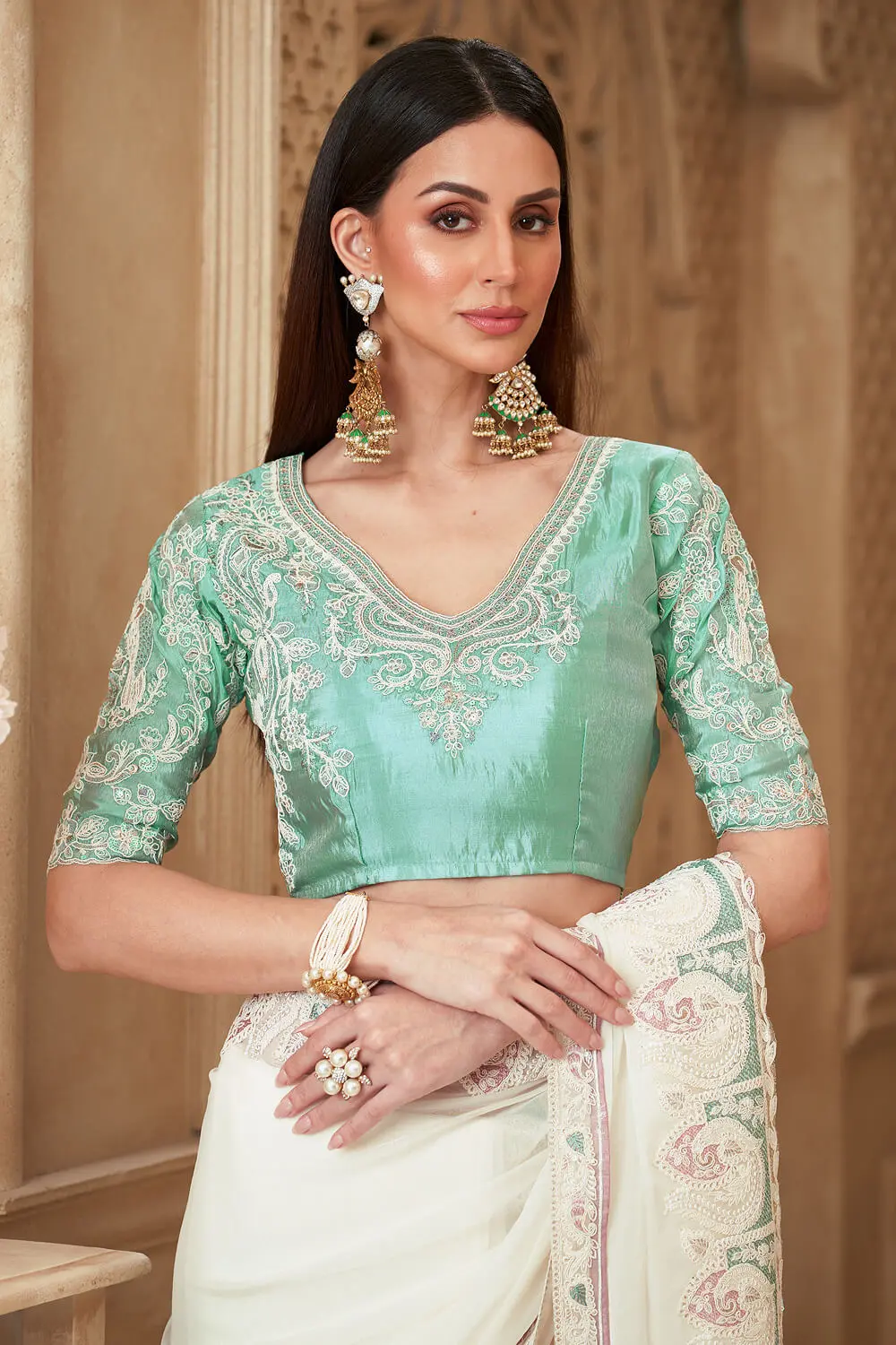 Satin silk blouse paired with Powder White Satin Georgette Embroidered Saree