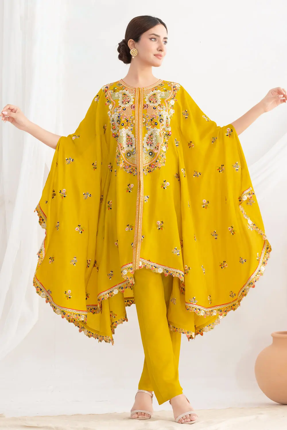 Close up of floral embroidery on mustard chinon silk kaftan sleeve