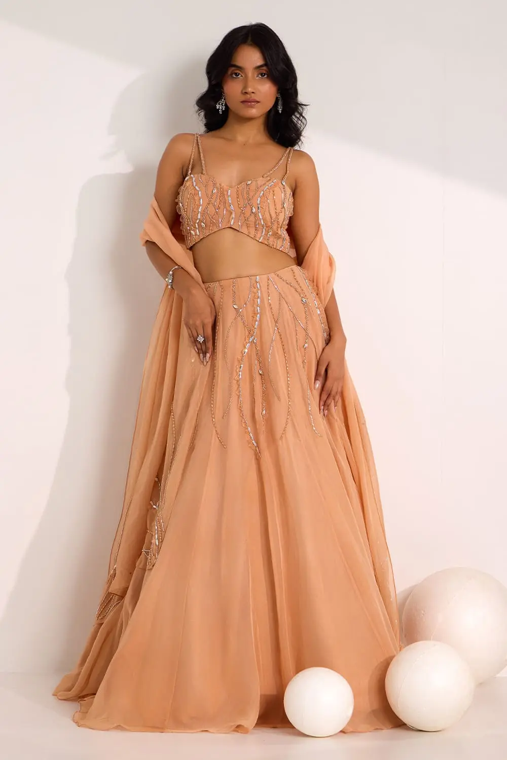 Rose gold organza lehenga choli with mix media embroidery by Khaish