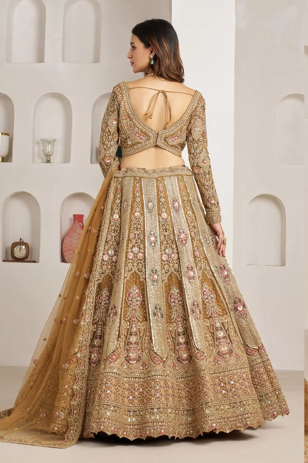 Back view of antique gold bridal lehenga choli with panel embroidery