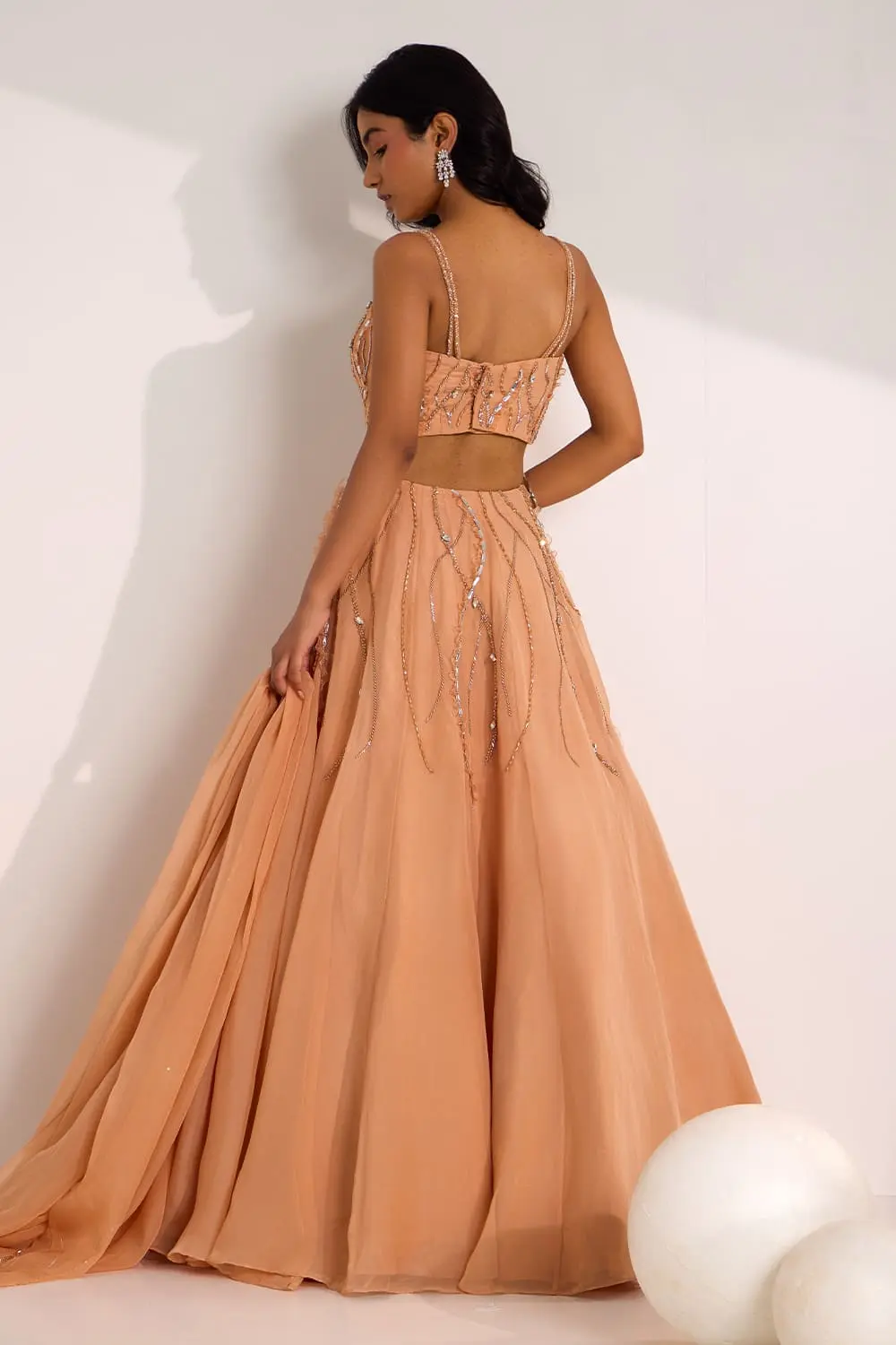 Back view of rose gold organza lehenga choli with embroidered dupatta
