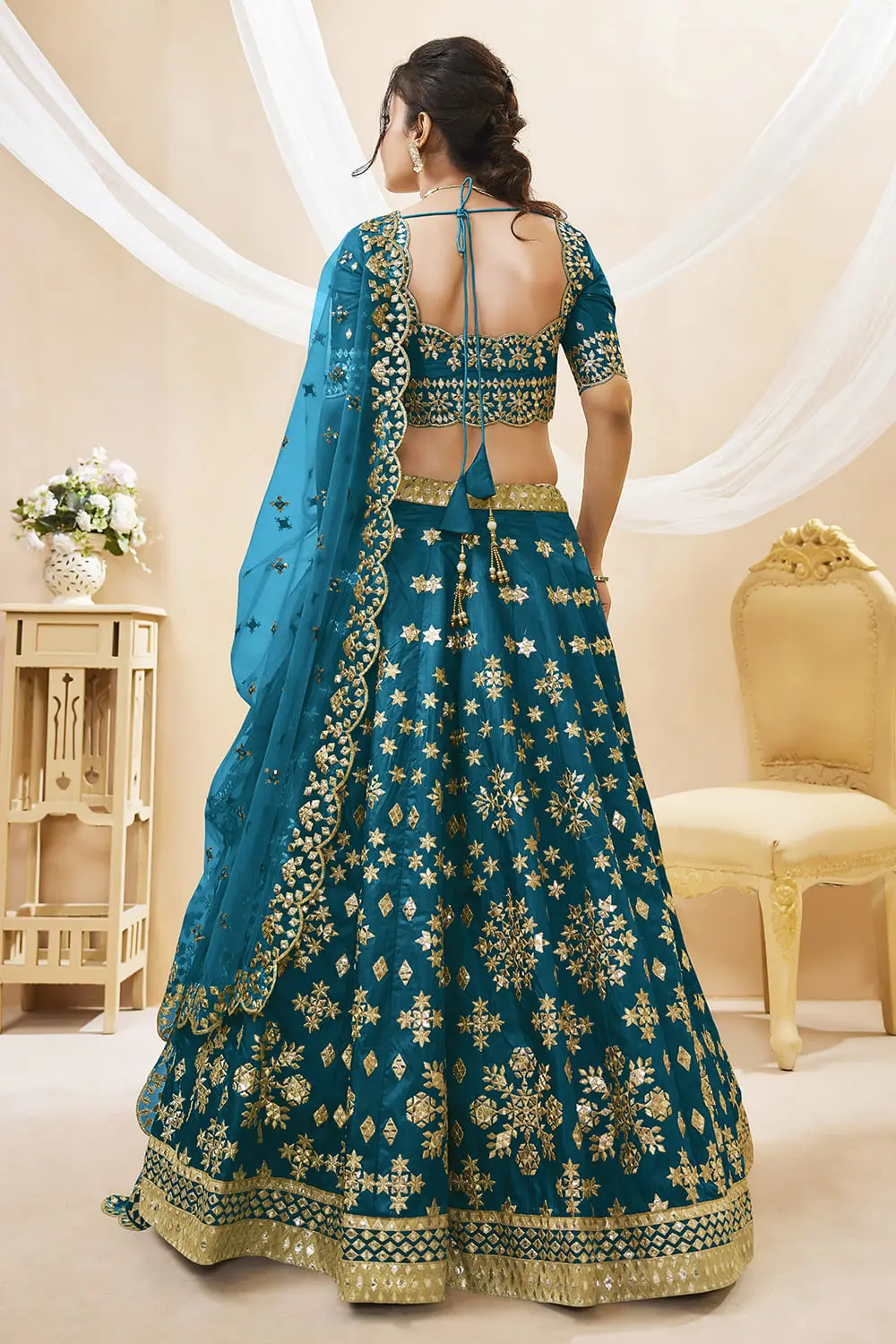 Back view of teal blue art silk lehenga choli with embroidered blouse