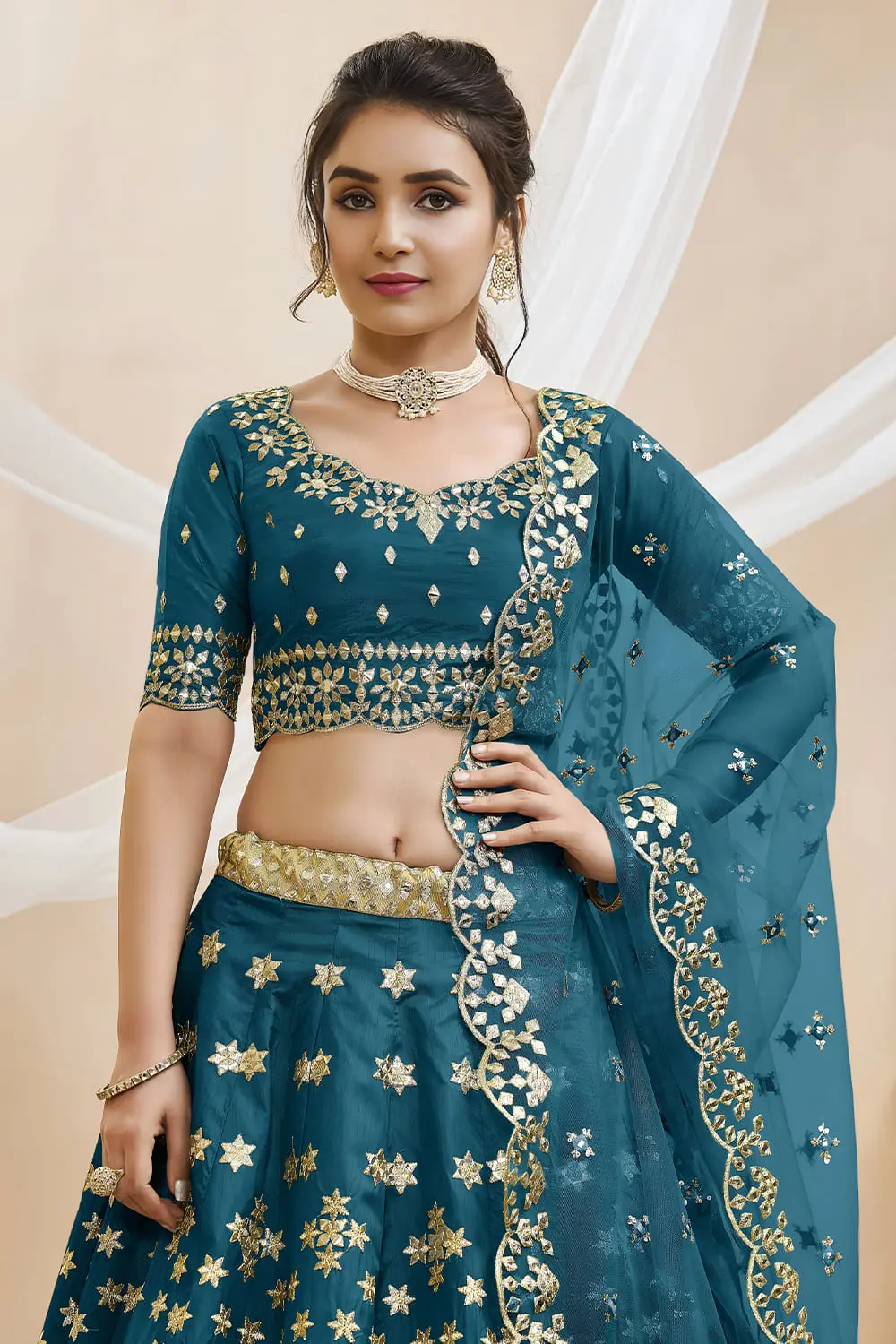Close up of sequins, foil and zari work on teal blue art silk lehenga