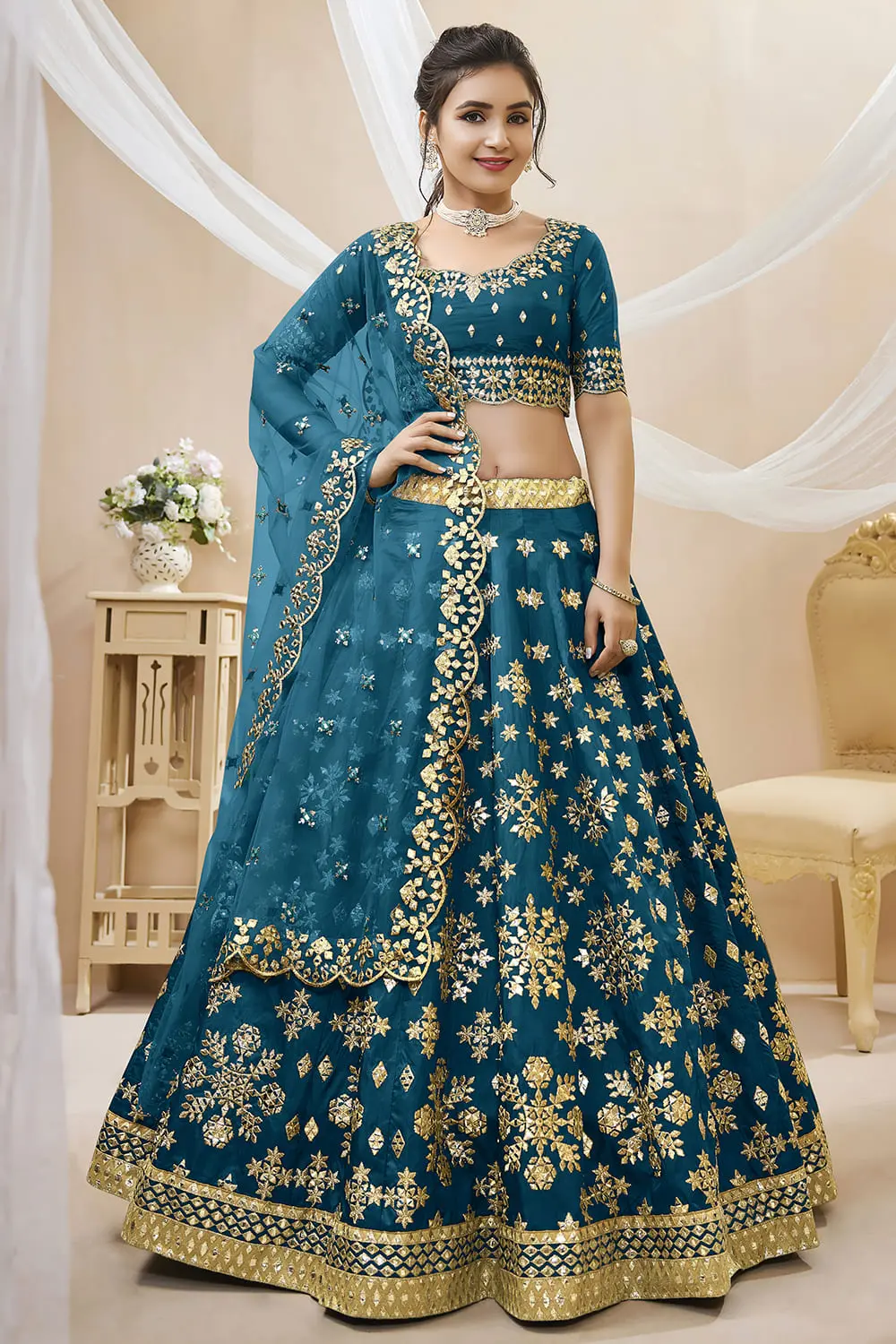 Teal blue art silk lehenga with foil and zari embroidery and net dupatta