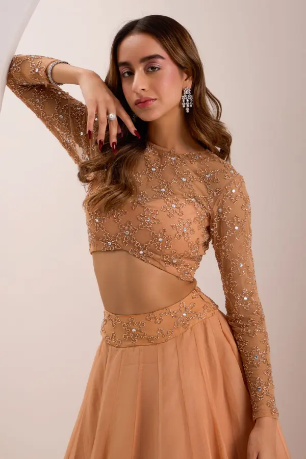 Close up of cut dana and crystal embroidery on rose gold lehenga