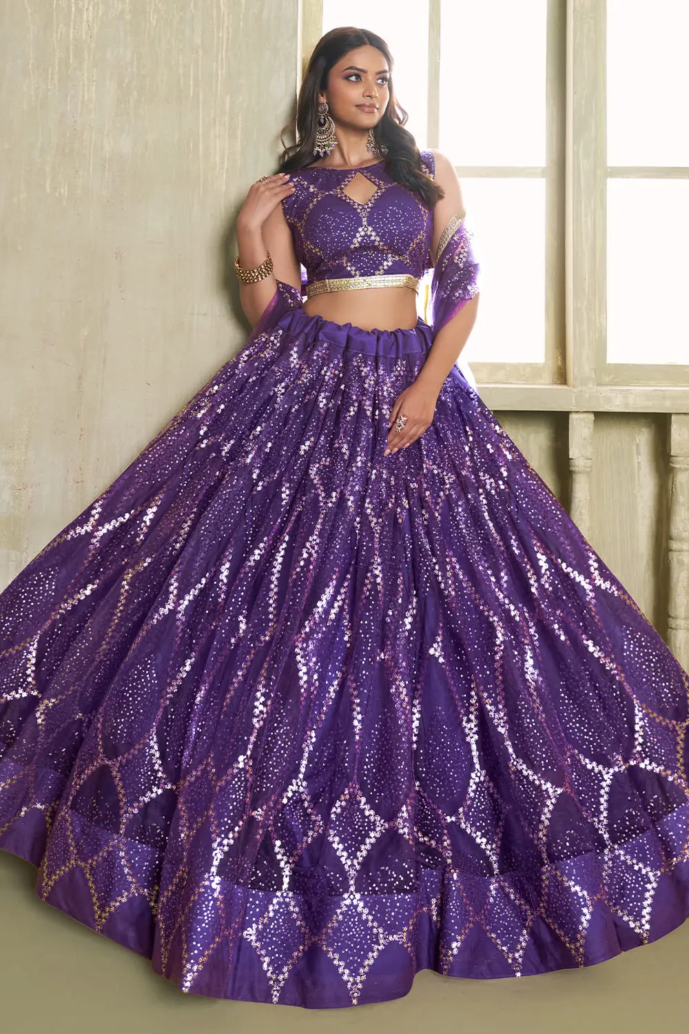 Deep purple butterfly net lehenga with fancy lace finish seated view
