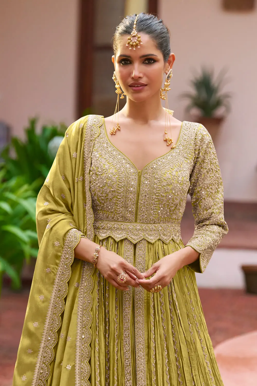 Close up of embroidery and handwork on olive green chinon anarkali skirt