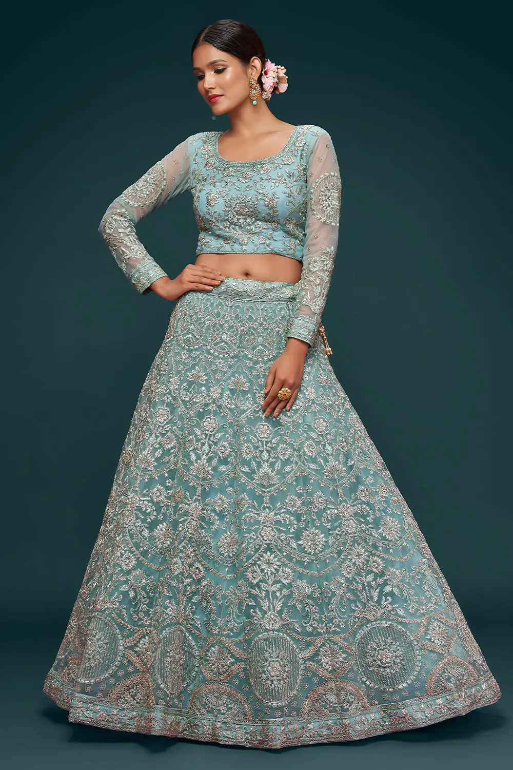 Aqua blue soft net lehenga styled with embroidered blouse and dupatta