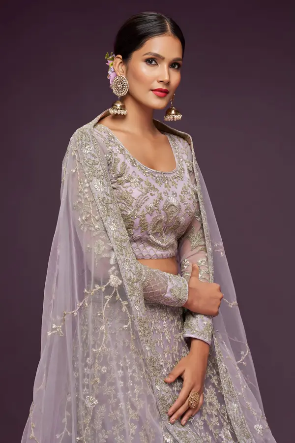 Dusty purple soft net lehenga styled with embroidered blouse and dupatta