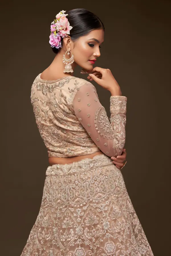 Golden badla and glitter dori embroidery on beige net lehenga skirt