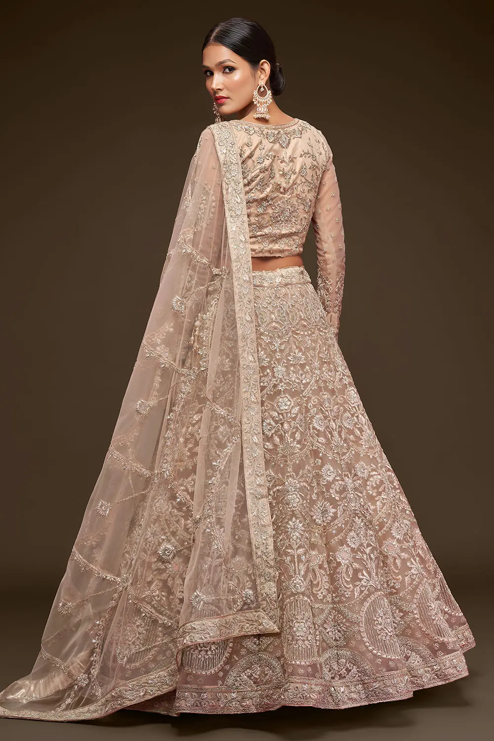 Beige soft net lehenga styled with embroidered blouse and dupatta