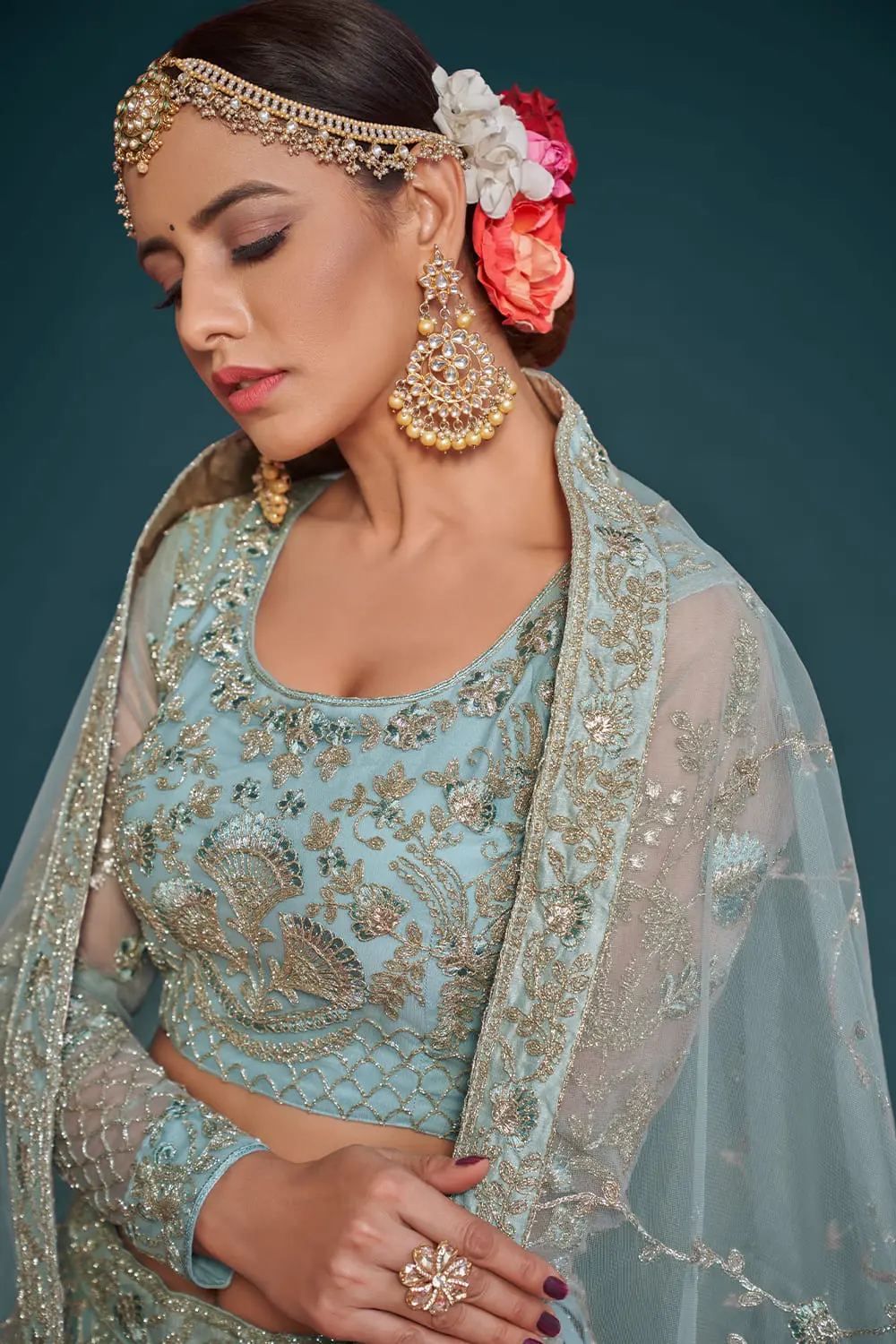 Sky blue soft net lehenga styled with embroidered blouse and dupatta