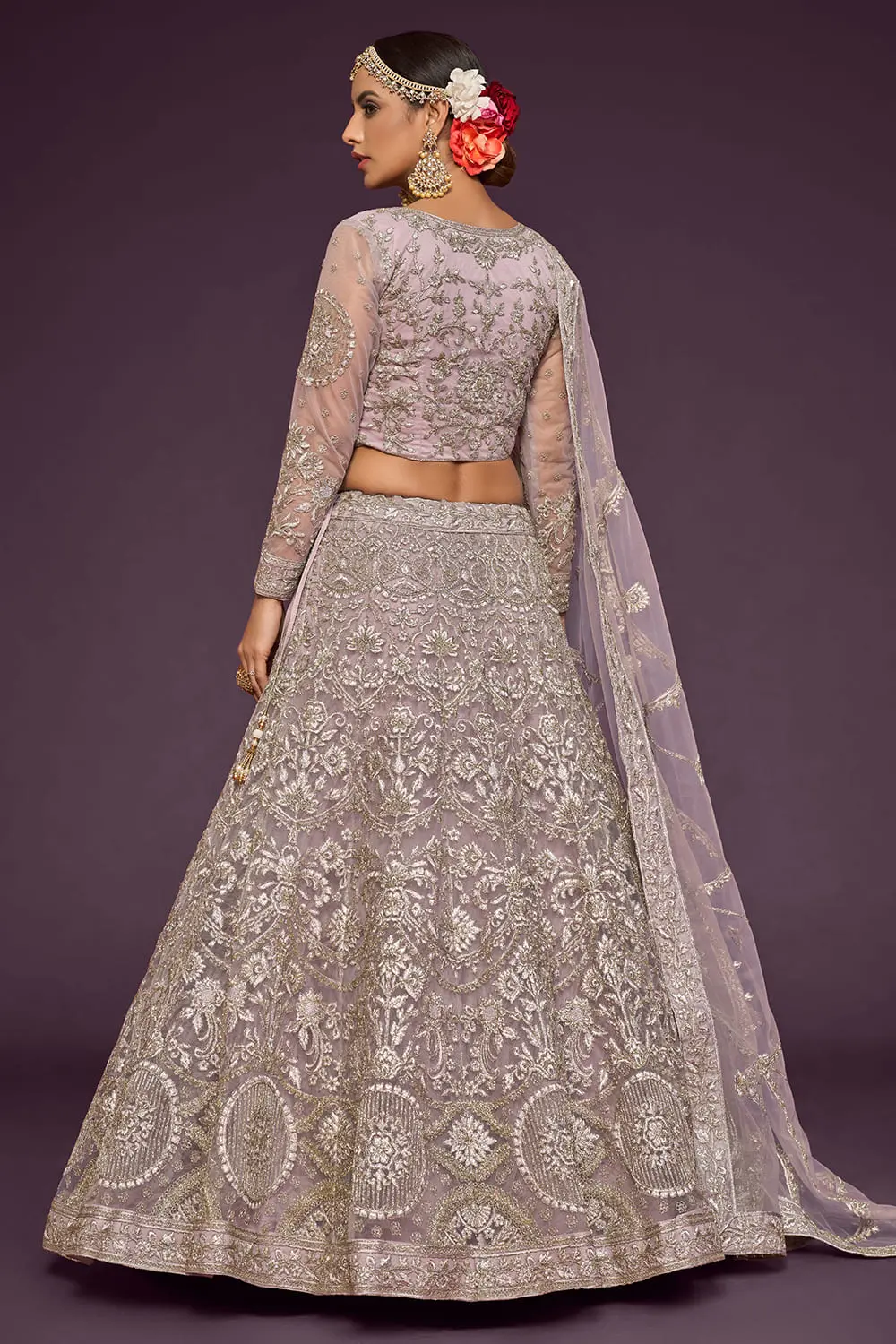 Lavender soft net lehenga styled with embroidered blouse and dupatta